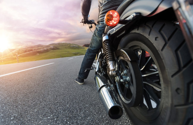 Close up of motorcycle rider driving in Alpine road