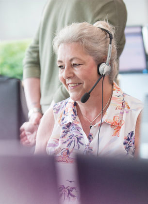 Woman in an office talking to a customer through a head set