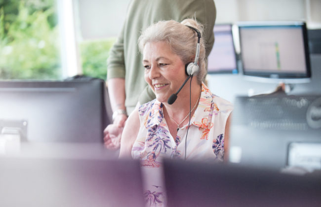 Woman in an office talking to a customer through a head set