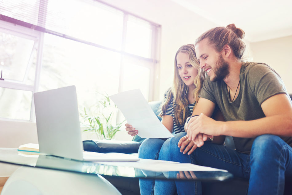 Shot of a young couple going through paperwork at home