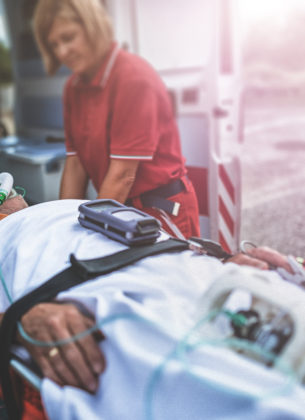 A rescue team takes a man into an ambulance