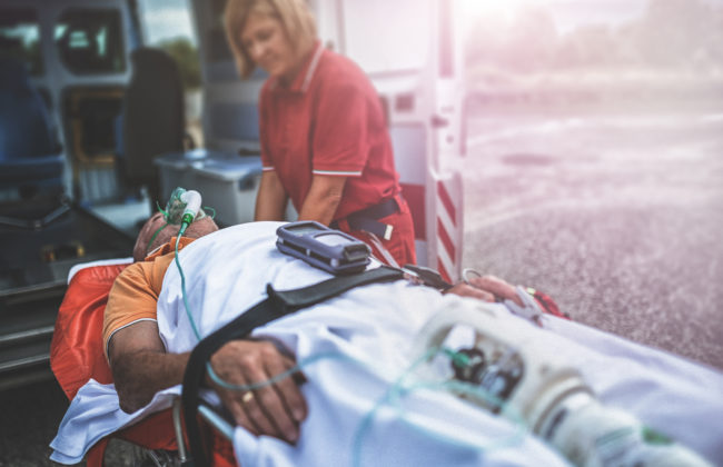 A rescue team takes a man into an ambulance