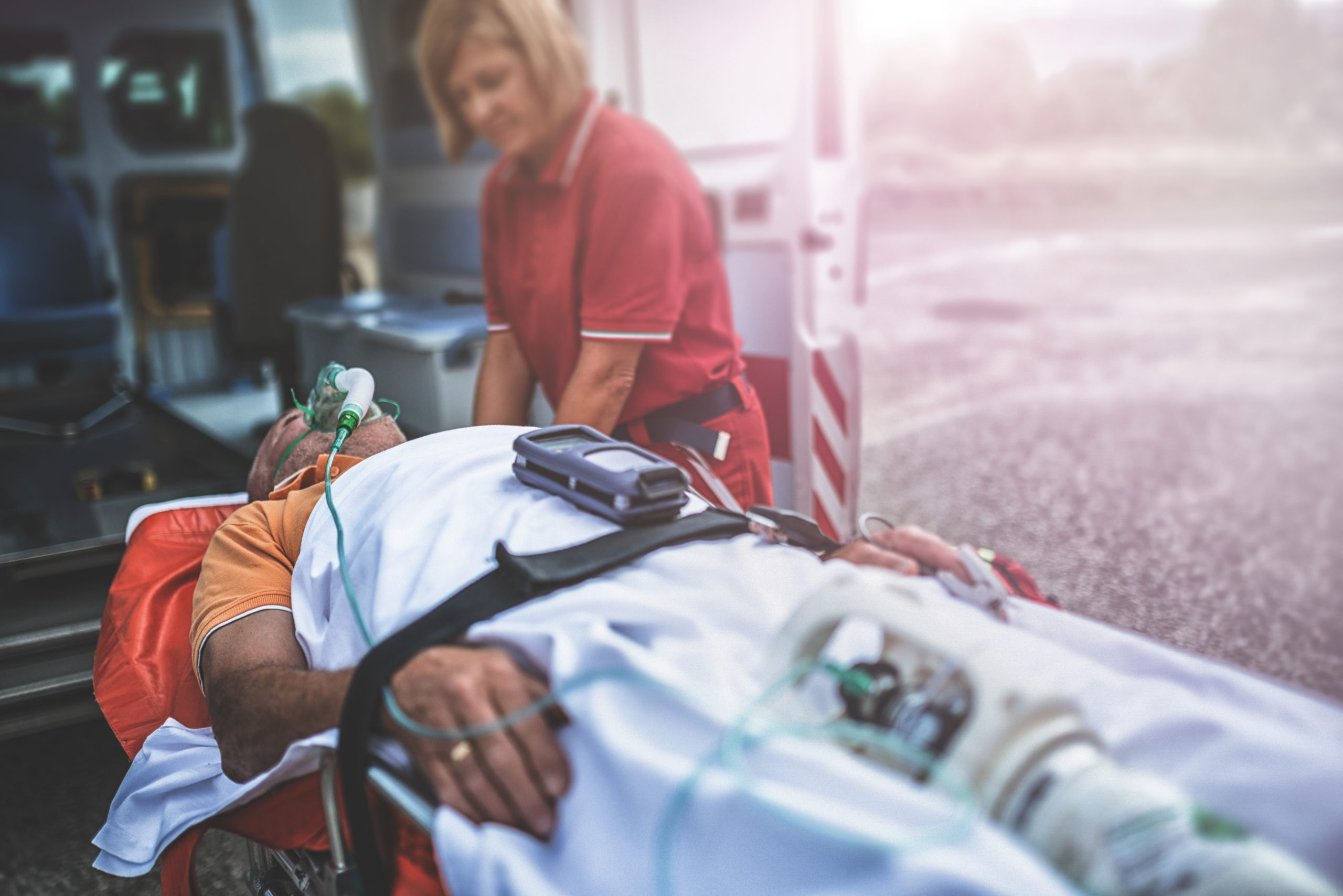 A rescue team takes a man into an ambulance