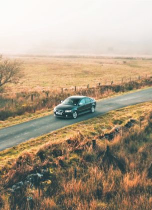Car driving down an English country road