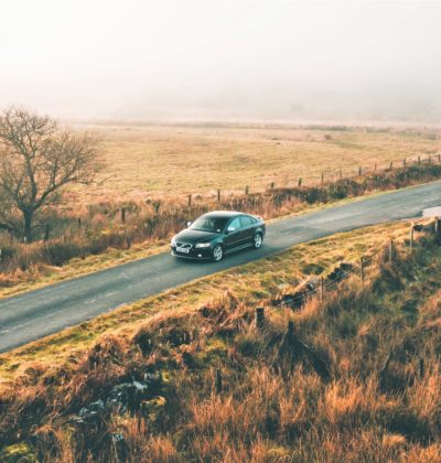 Car driving down an English country road