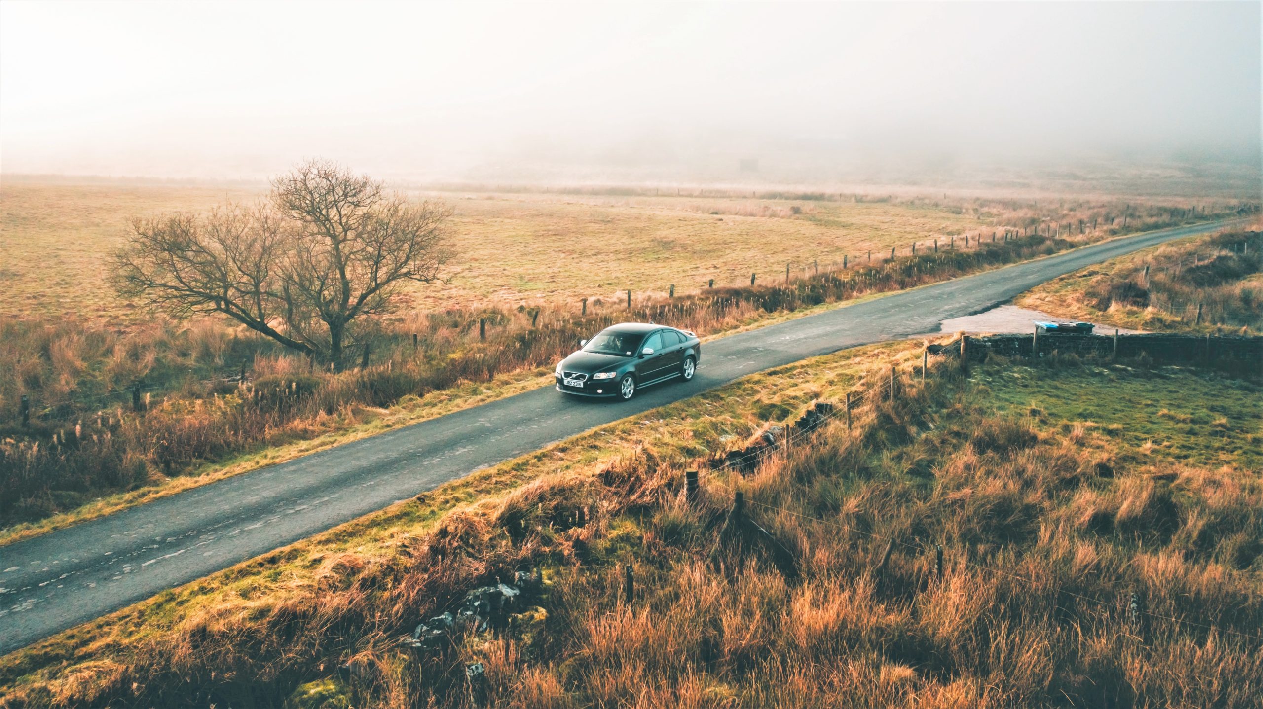 Car driving down an English country road