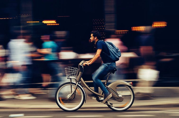 Man cycles through city