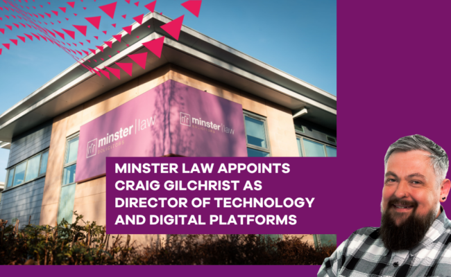 Photo of a modern office building with a large purple “minster law” sign on the corner, set against a clear blue sky. A bold purple graphic panel overlays the right side of the image with a cut-out portrait of a person in a checkered shirt. White uppercase text reads: “MINSTER LAW APPOINTS CRAIG GILCHRIST AS DIRECTOR OF TECHNOLOGY AND DIGITAL PLATFORMS.” Pink triangular design elements appear across the top left corner.
