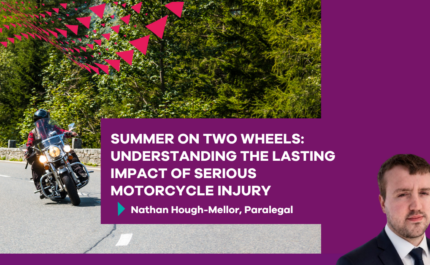 Promotional graphic featuring a motorcyclist riding on a curved road bordered by trees and a stone wall. A large purple text panel overlays the image with the headline: “Summer on Two Wheels: Understanding the Lasting Impact of Serious Motorcycle Injury.” Beneath the headline is the byline: “Nathan Hough-Mellor, Paralegal.” Decorative pink triangular shapes appear in the upper left corner. A professional headshot of a person in a suit is positioned in the bottom right against a purple background.